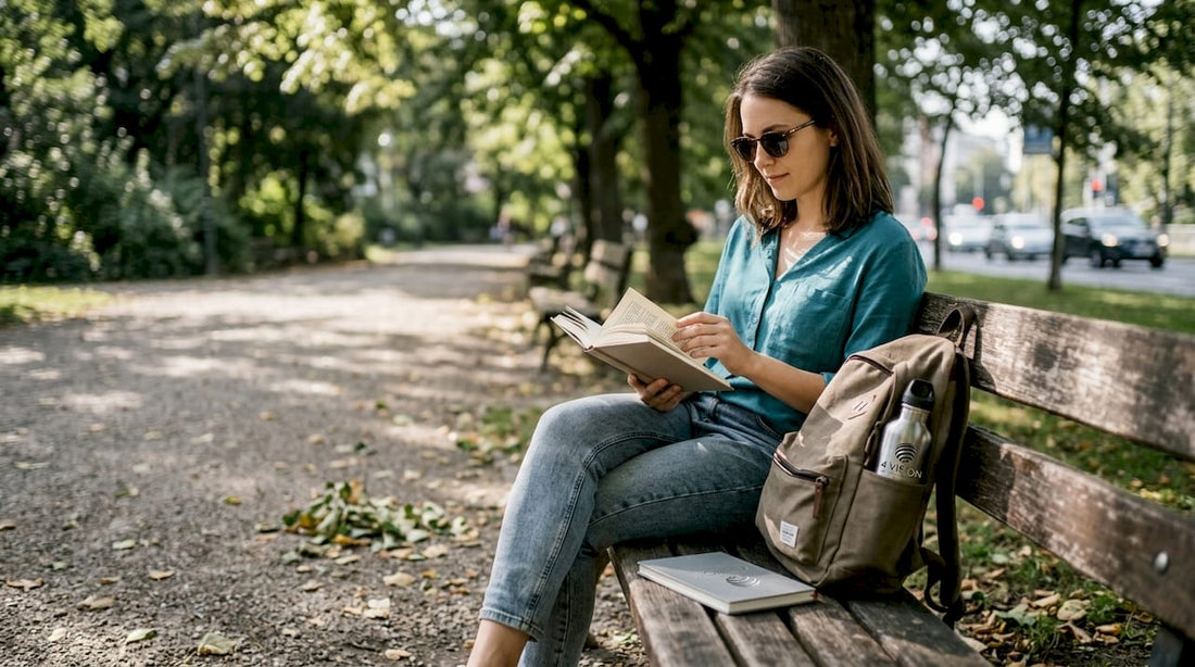 Woman reading in park wearing sunglasses